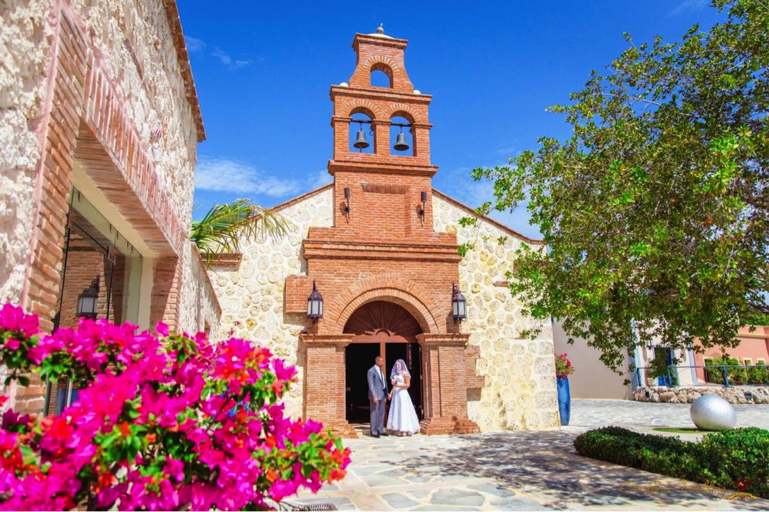 Colonial stone chapel at Fishing Lodge village in Cap Cana with bougainvillea